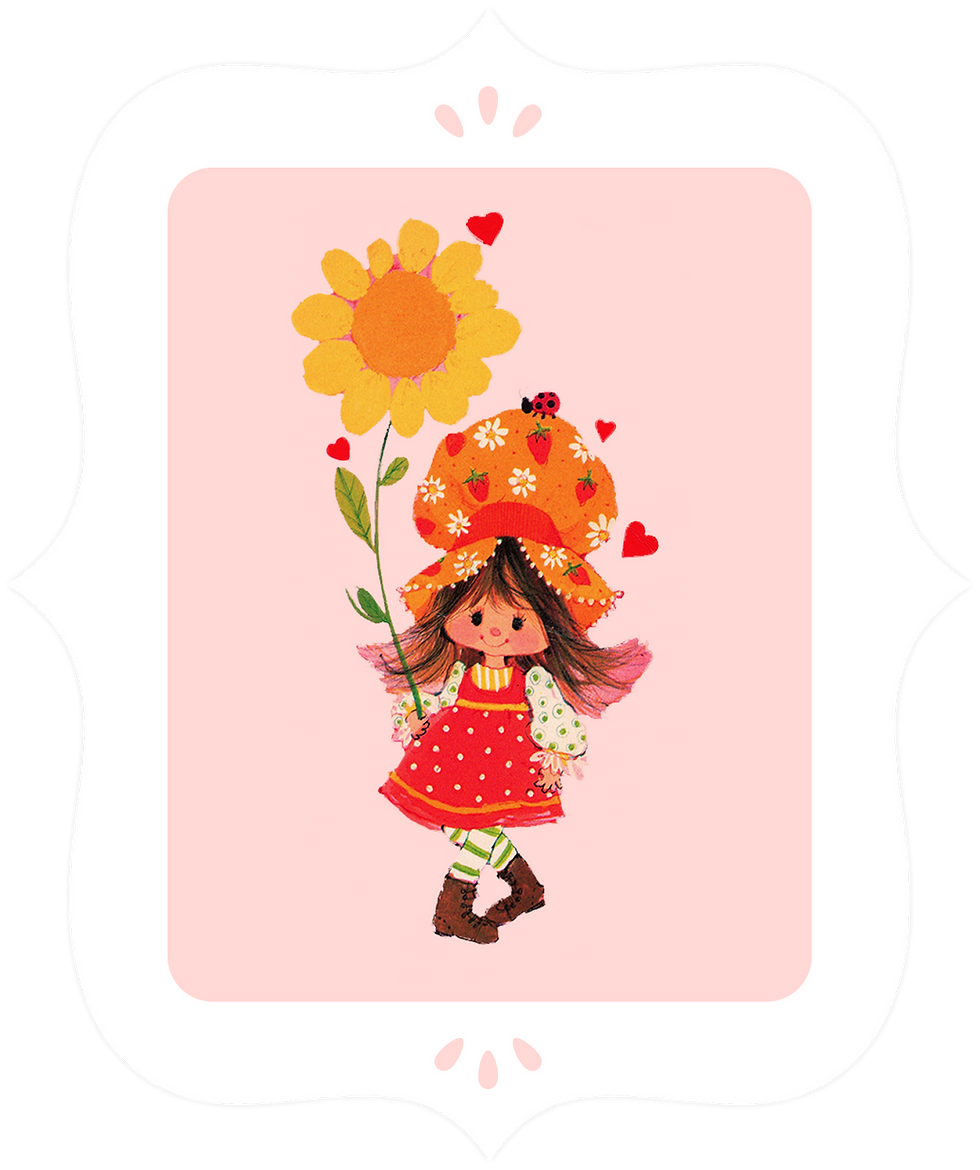 A girl wearing a red dress and large orange hat holding a large orange flower.